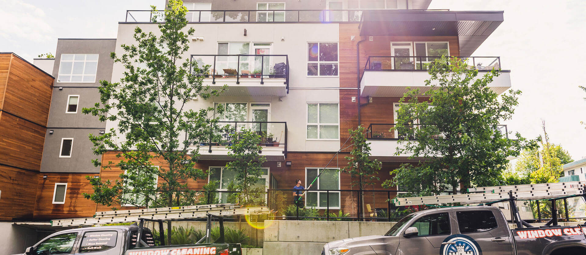 man cleaning windows on a multistorey building